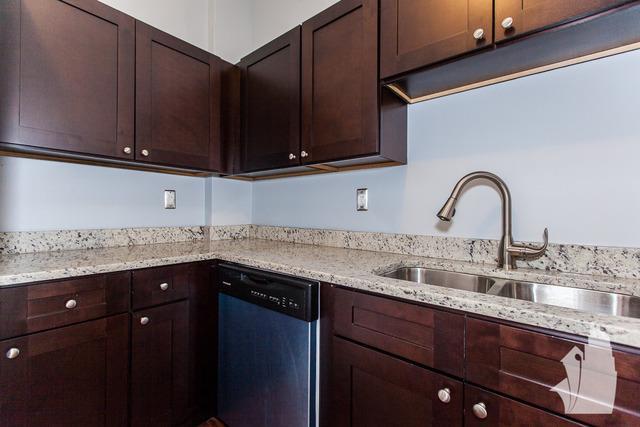 Undisclosed Address Chicago, IL 60614 - Photo 2 of 18 a kitchen with granite countertop a sink and cabinets