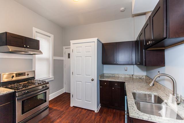 Undisclosed Address Chicago, IL 60614 - Photo 3 of 18 a kitchen with stainless steel appliances granite countertop a stove a sink and a microwave