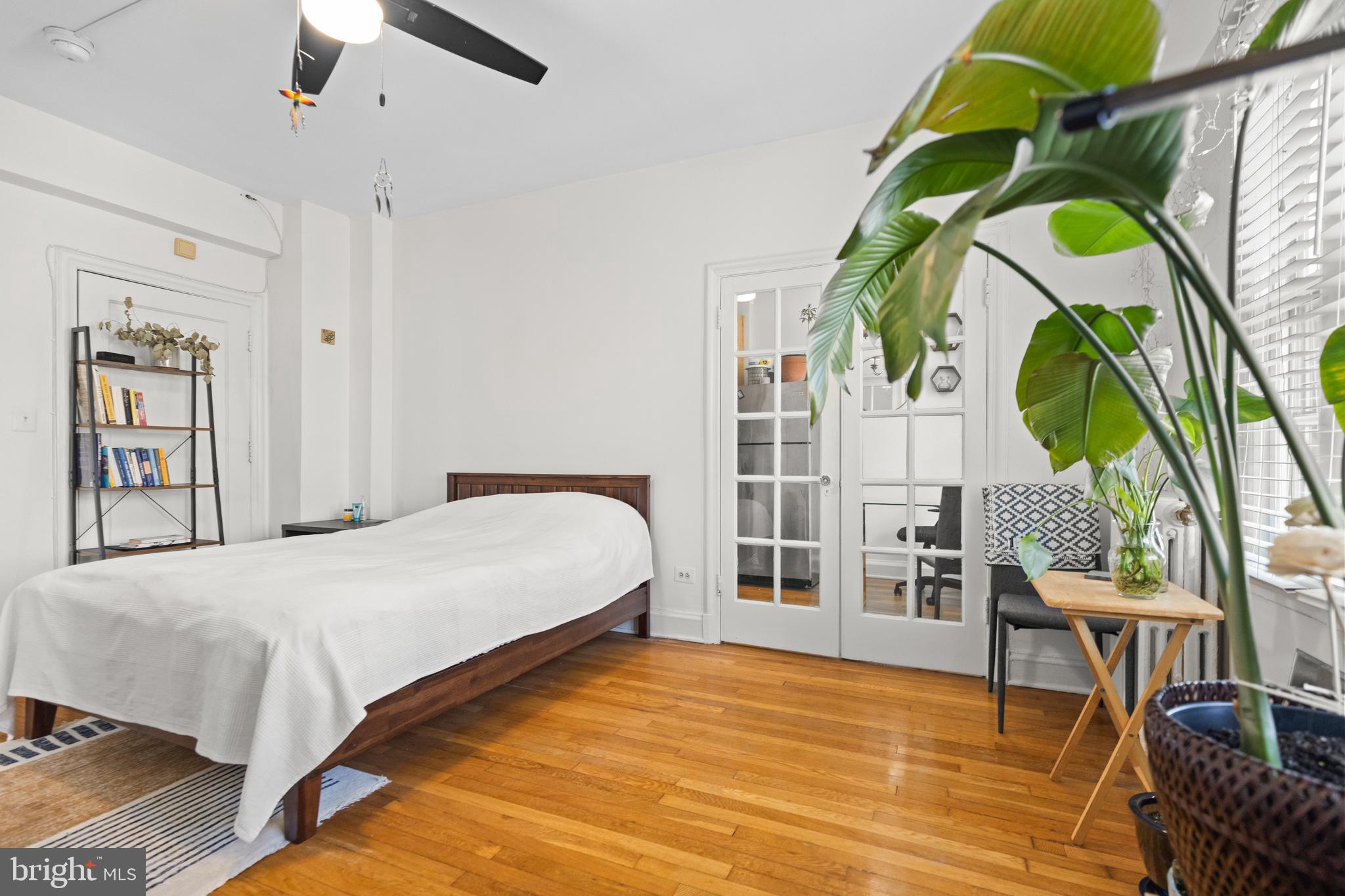 2032 Belmont Road Northwest, Unit 204 Washington, DC 20009 - Photo 13 of 25 a bedroom with a bed a dresser and chair