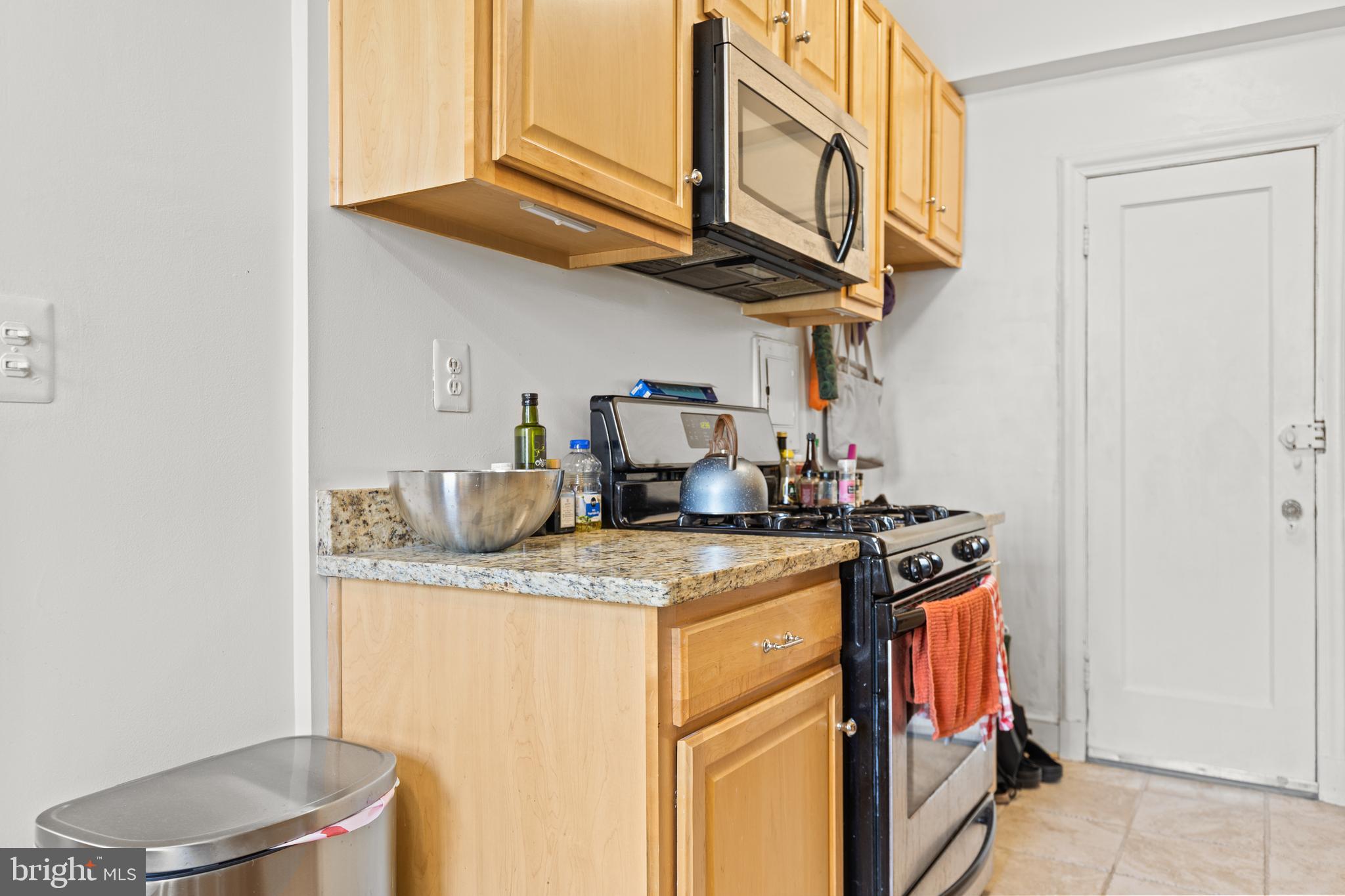 2032 Belmont Road Northwest, Unit 204 Washington, DC 20009 - Photo 15 of 25 a kitchen with stainless steel appliances granite countertop a sink stove and cabinets