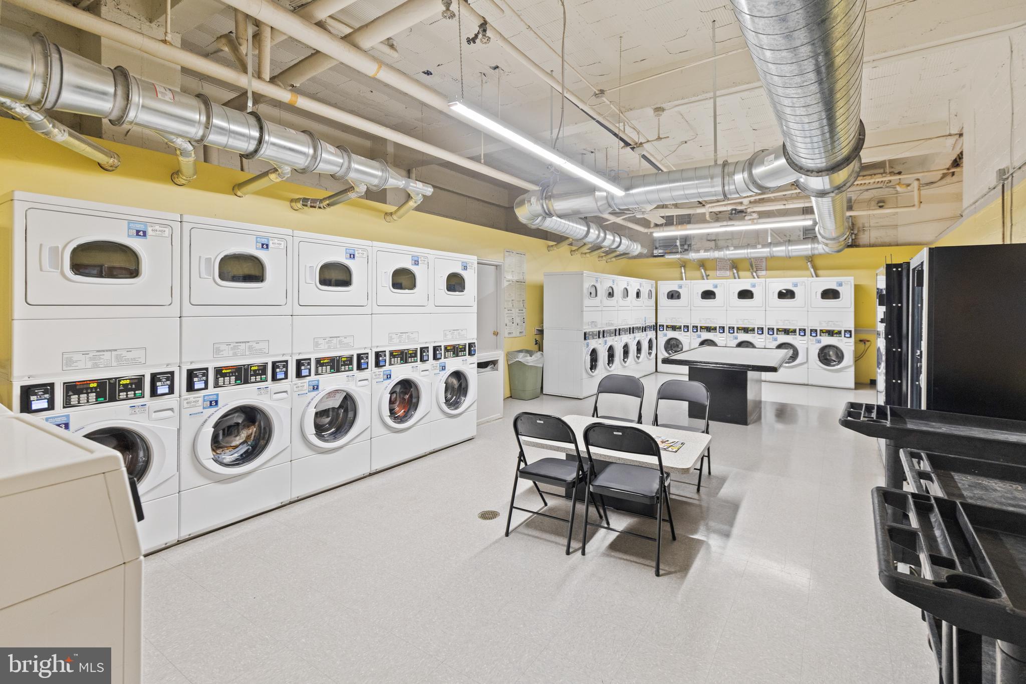 2032 Belmont Road Northwest, Unit 204 Washington, DC 20009 - Photo 18 of 25 a utility room with multiple dryer and washer