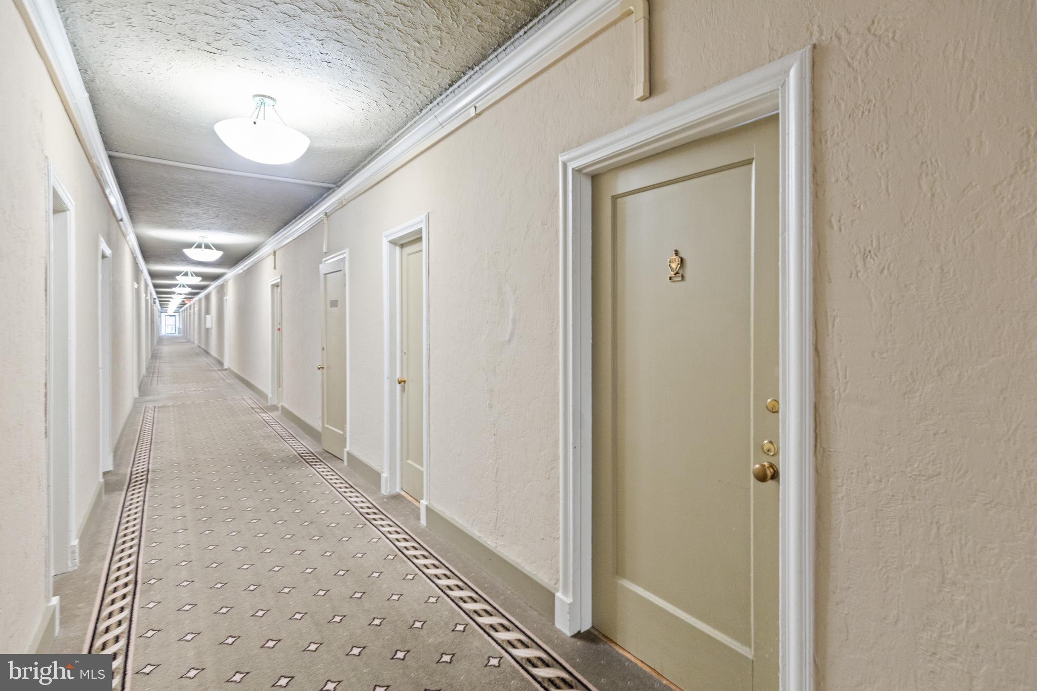 2032 Belmont Road Northwest, Unit 204 Washington, DC 20009 - Photo 5 of 25 a view of a hallway with wooden floor and staircase