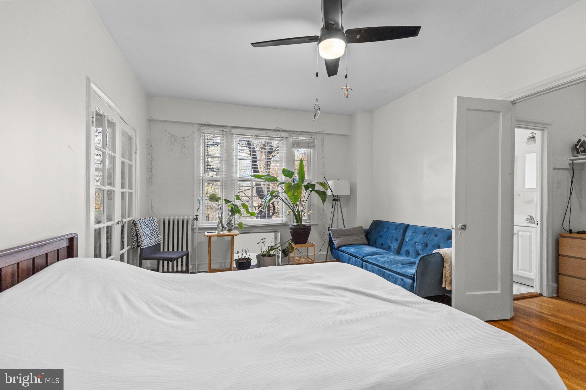 2032 Belmont Road Northwest, Unit 204 Washington, DC 20009 - Photo 7 of 25 a bedroom with a bed furniture and a large window
