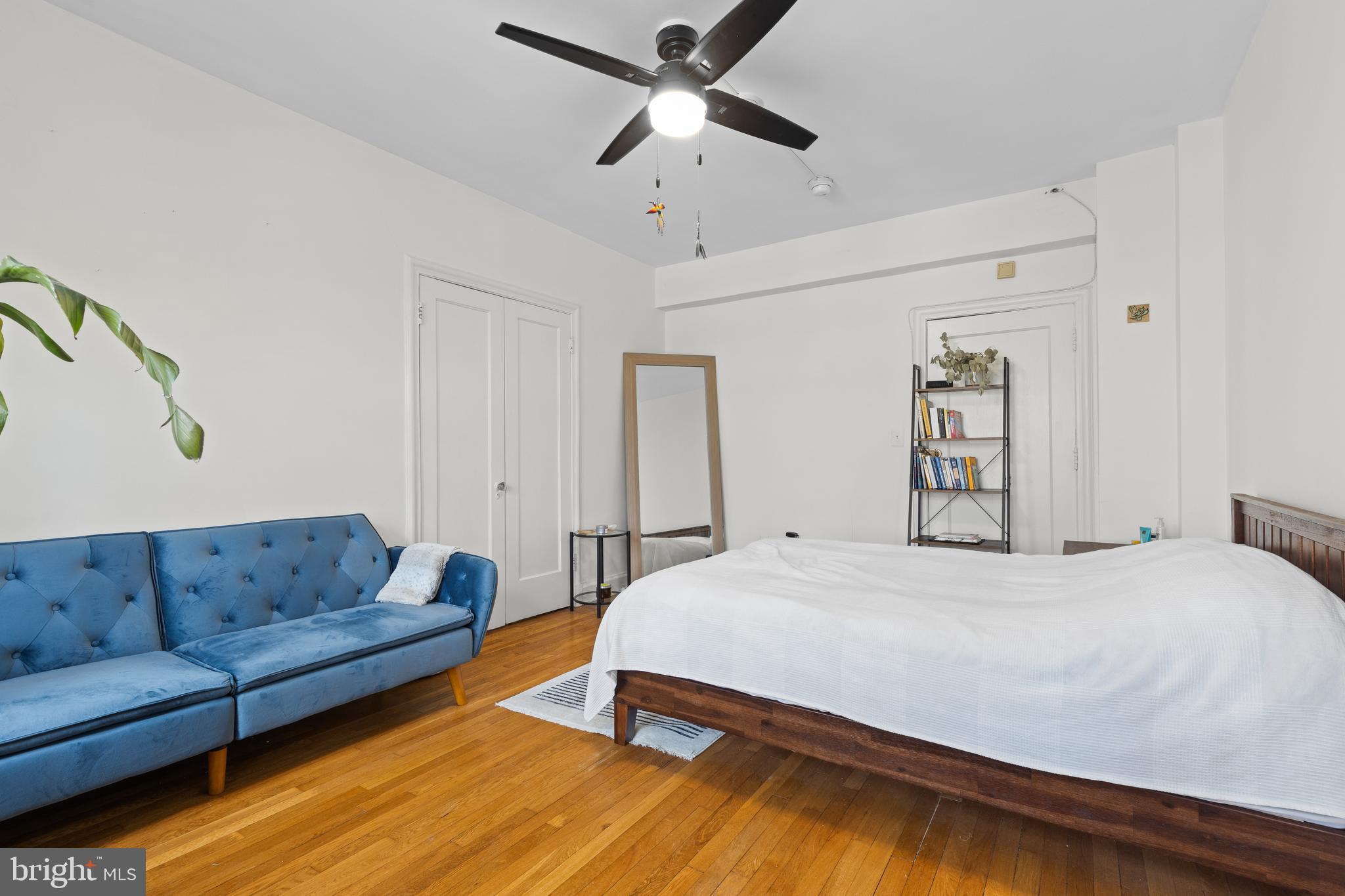 2032 Belmont Road Northwest, Unit 204 Washington, DC 20009 - Photo 8 of 25 a bedroom with a bed couch and window