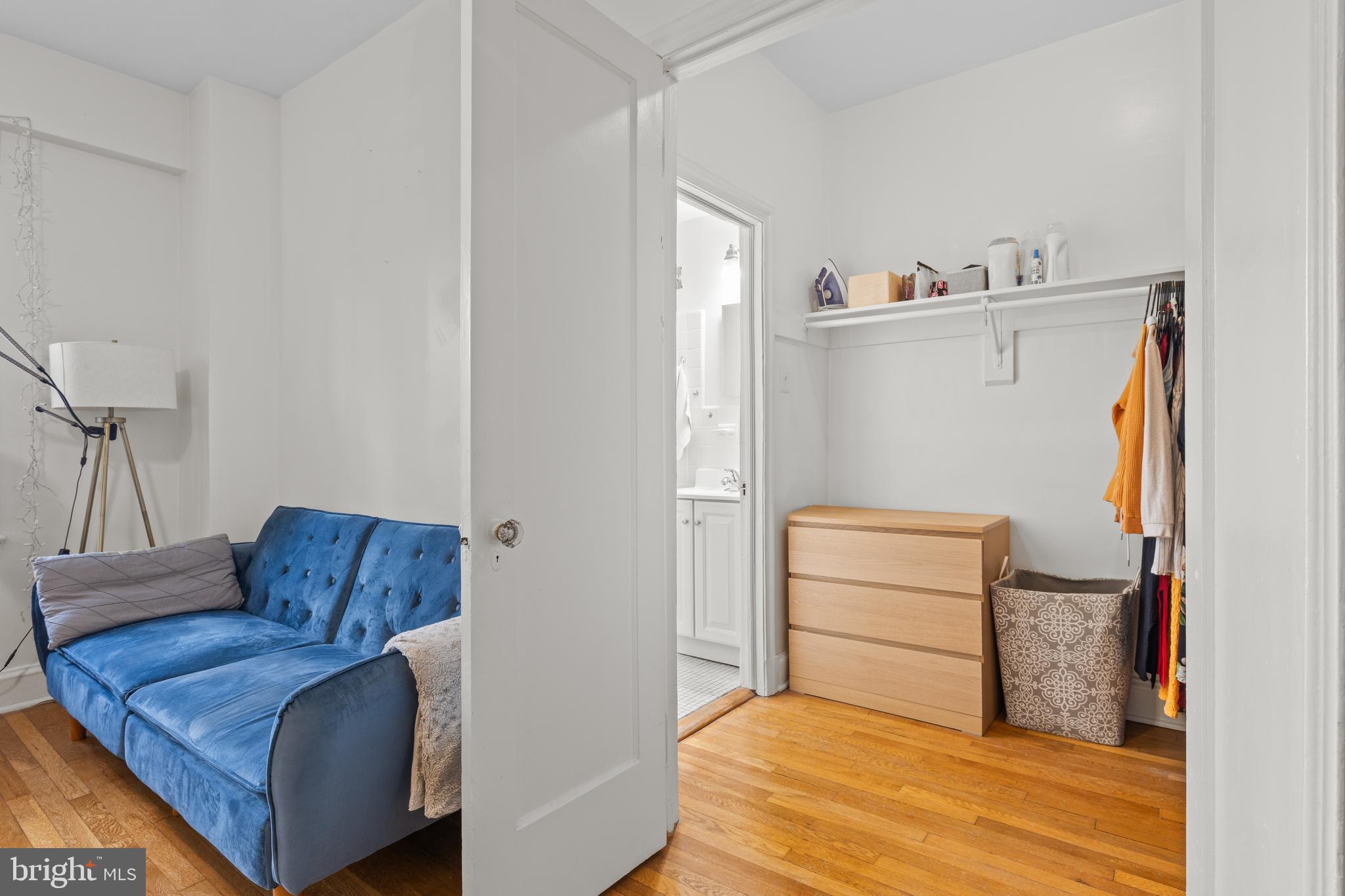 2032 Belmont Road Northwest, Unit 204 Washington, DC 20009 - Photo 10 of 25 a bedroom with a bed and a couch