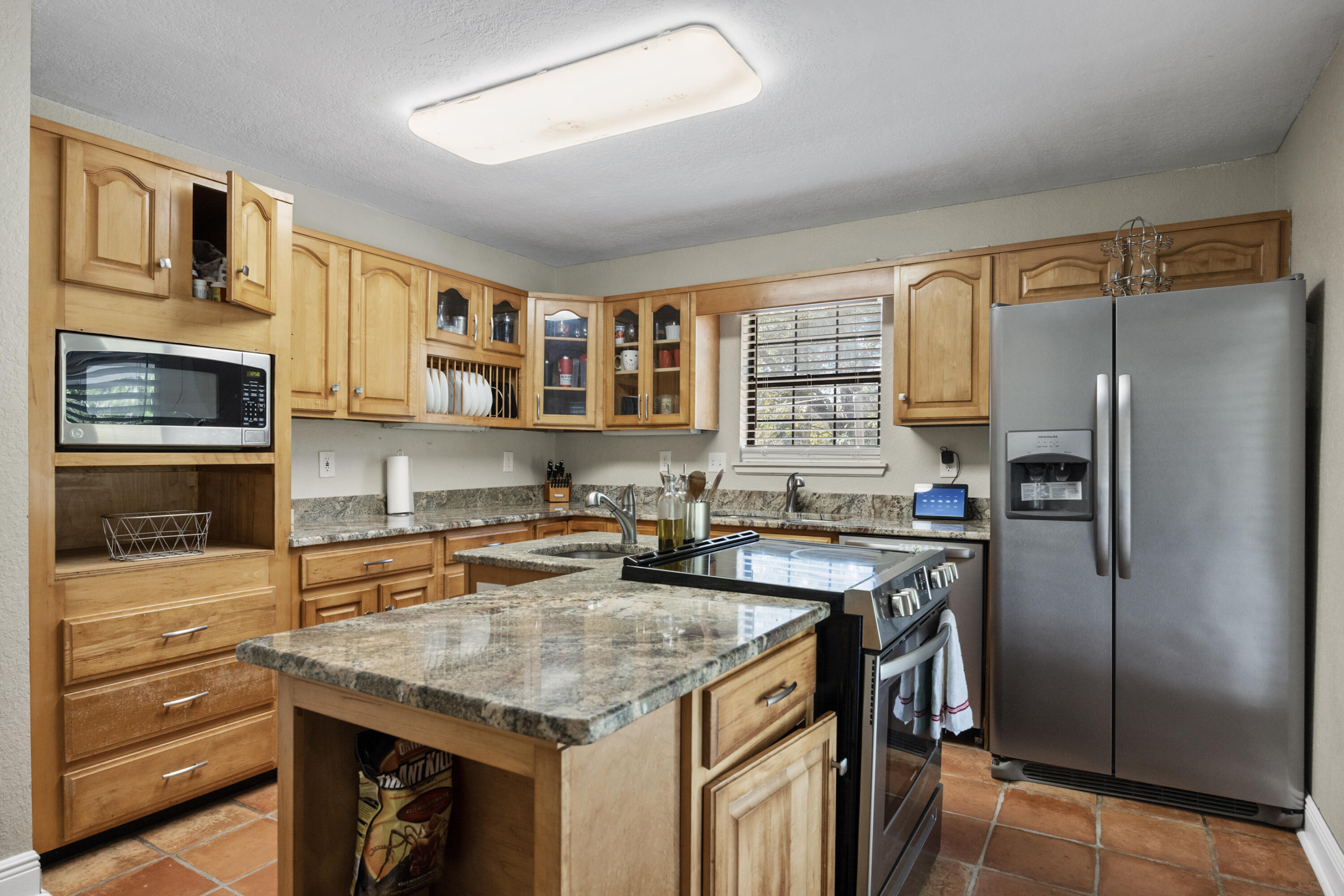 6106 Barnes Road Crestview, FL 32536 - Photo 10 of 49 a kitchen with stainless steel appliances granite countertop a refrigerator a stove a sink and a microwave