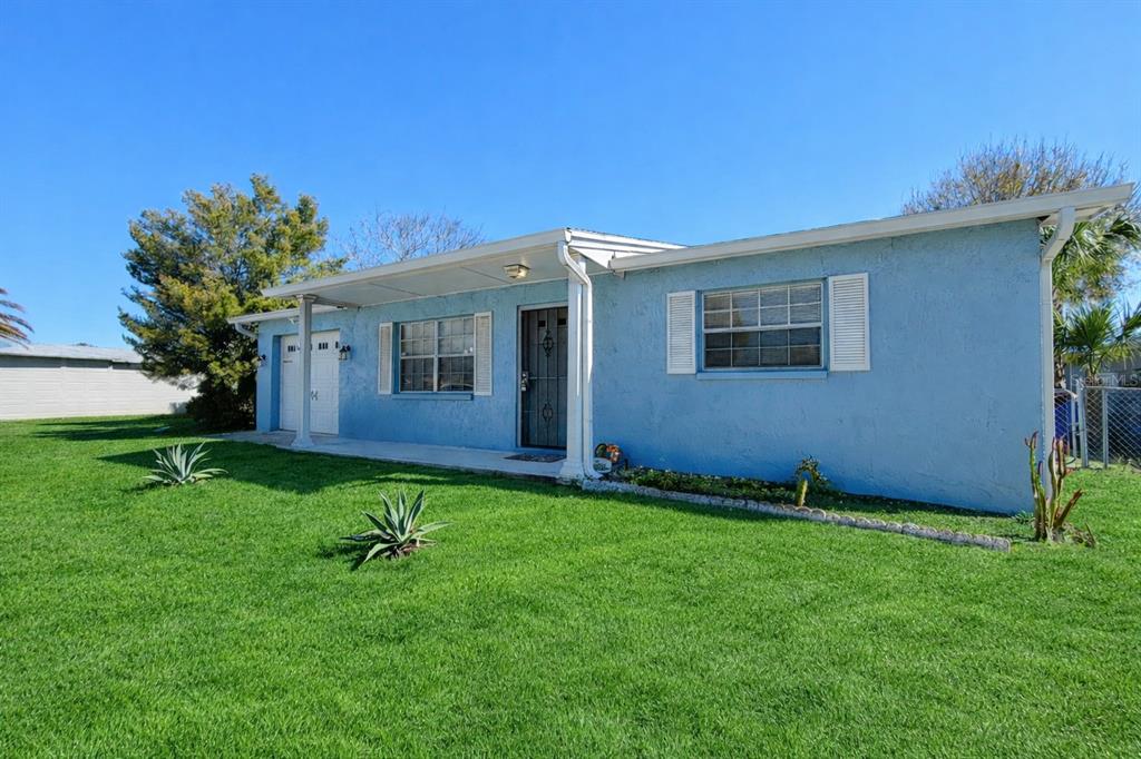 9840 Crofton Lane Port Richey, FL 34668 - Photo 1 of 12 a view of an house with backyard space and garden