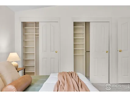a bedroom with a bed and cabinets