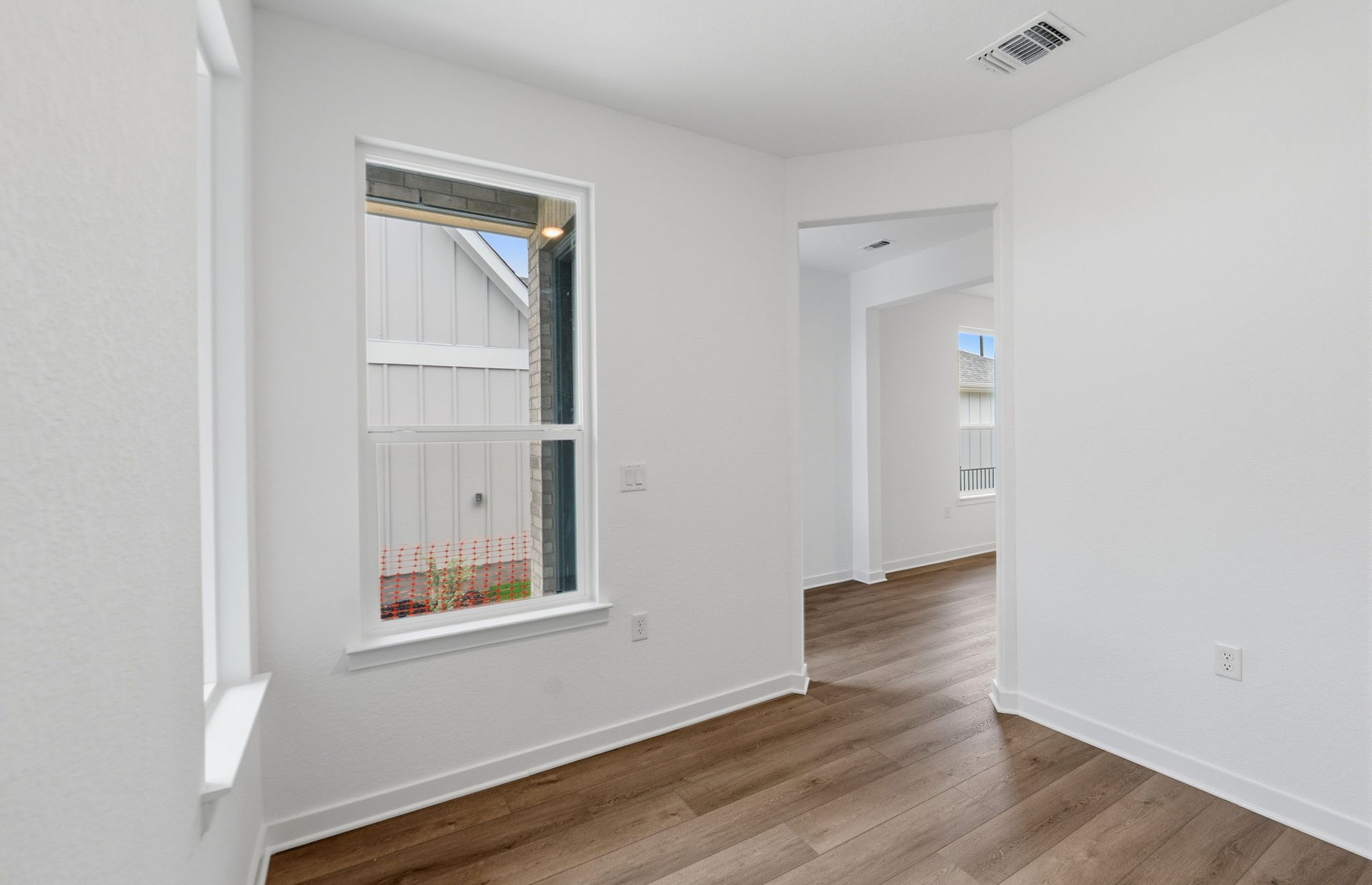 1010 Martingale Street Georgetown, TX 78633 - Photo 14 of 23 a view of an empty room with wooden floor and a window