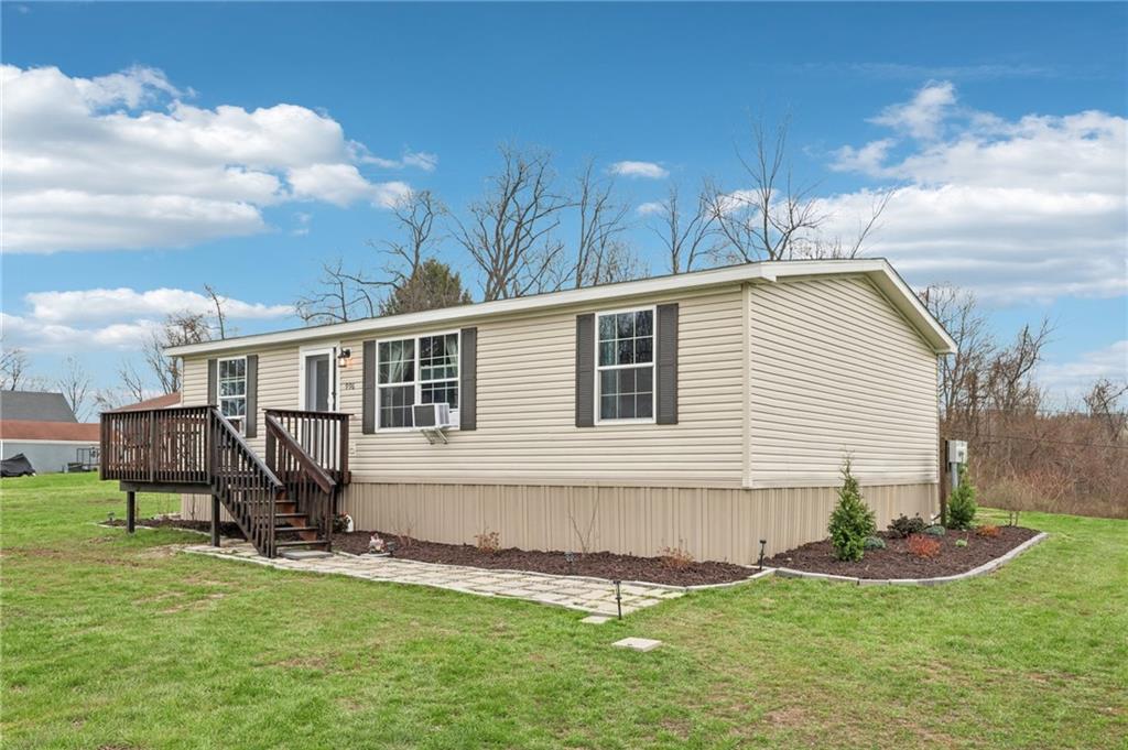 a view of a house with a yard and sitting area