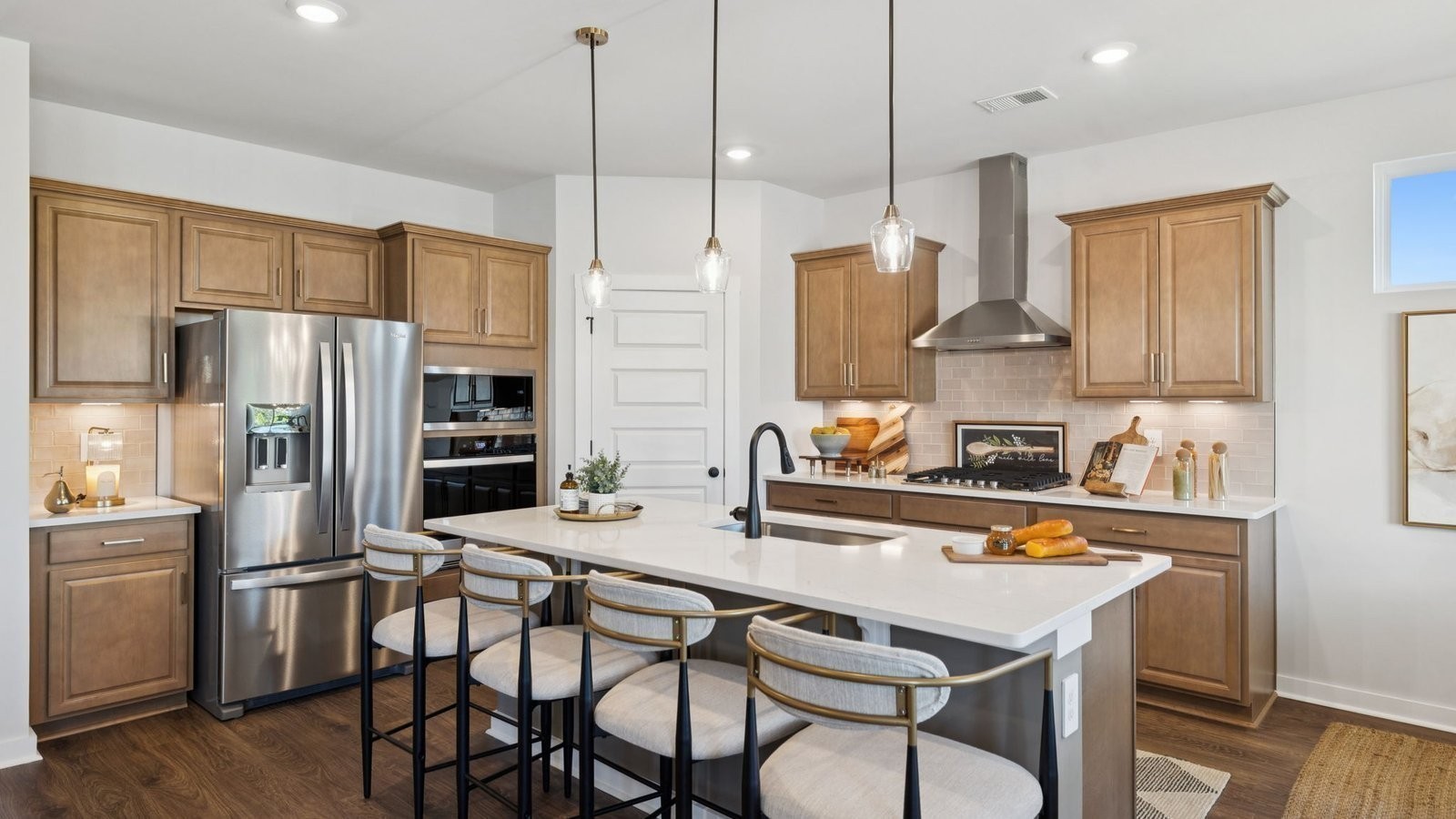 298 Harvest Point Boulevard Spring Hill, TN 37174 - Photo 19 of 70 a kitchen with stainless steel appliances a dining table chairs sink and cabinets