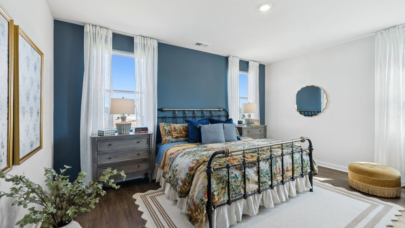 298 Harvest Point Boulevard Spring Hill, TN 37174 - Photo 30 of 70 a bedroom with a bed lamp and a potted plant