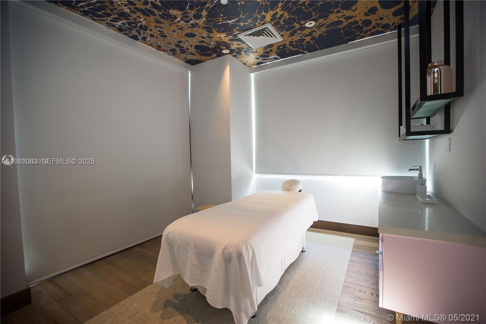 121 Northeast 34th Street, Unit 1604 Miami, FL 33137 - Photo 34 of 53 a bedroom with a bed and a night stand