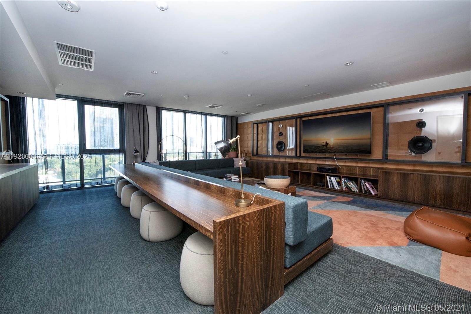 121 Northeast 34th Street, Unit 1604 Miami, FL 33137 - Photo 36 of 53 a living room with furniture and a flat screen tv