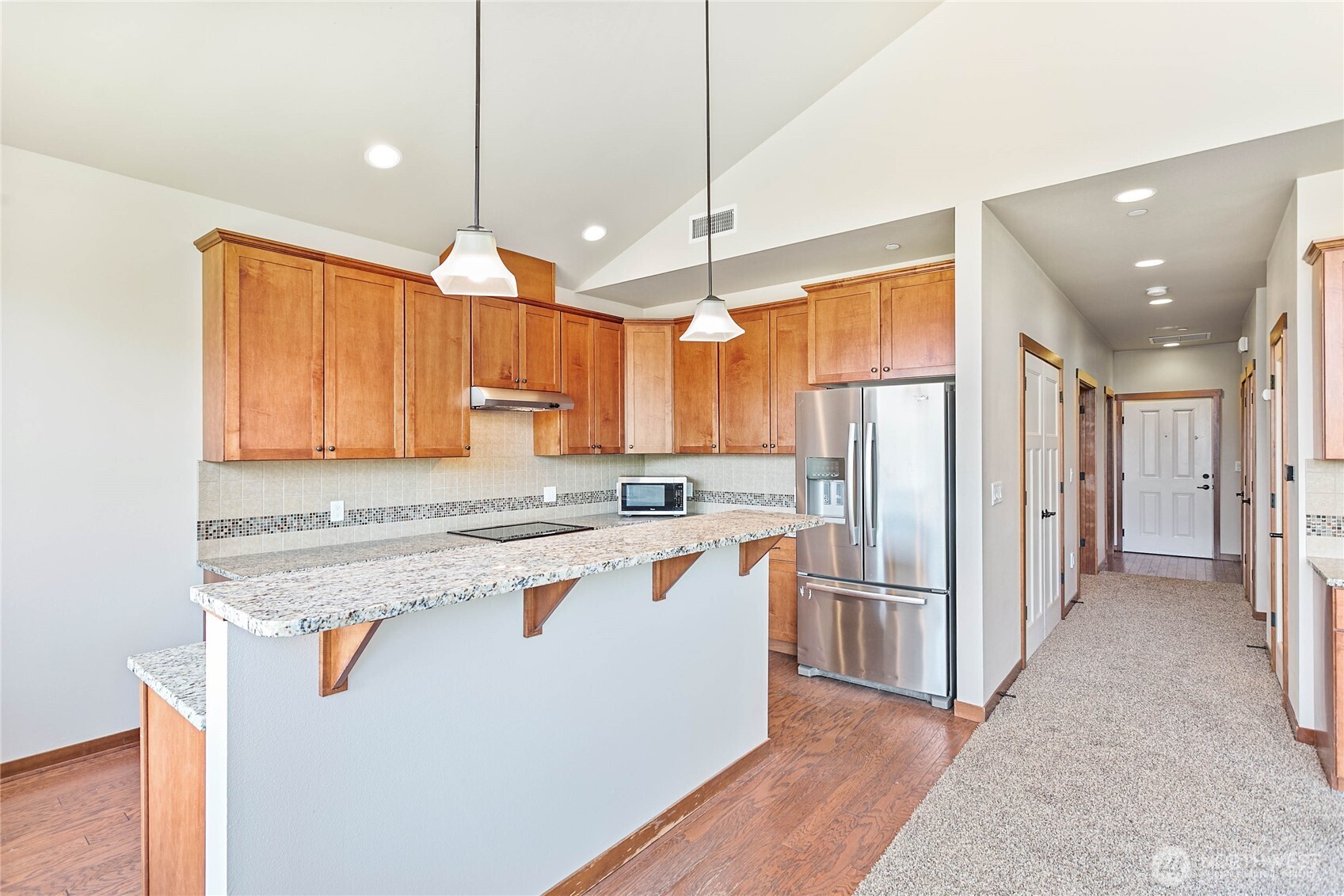8780 Depot Road, Unit 308 Lynden, WA 98264 - Photo 11 of 36 a kitchen with refrigerator a sink and cabinets