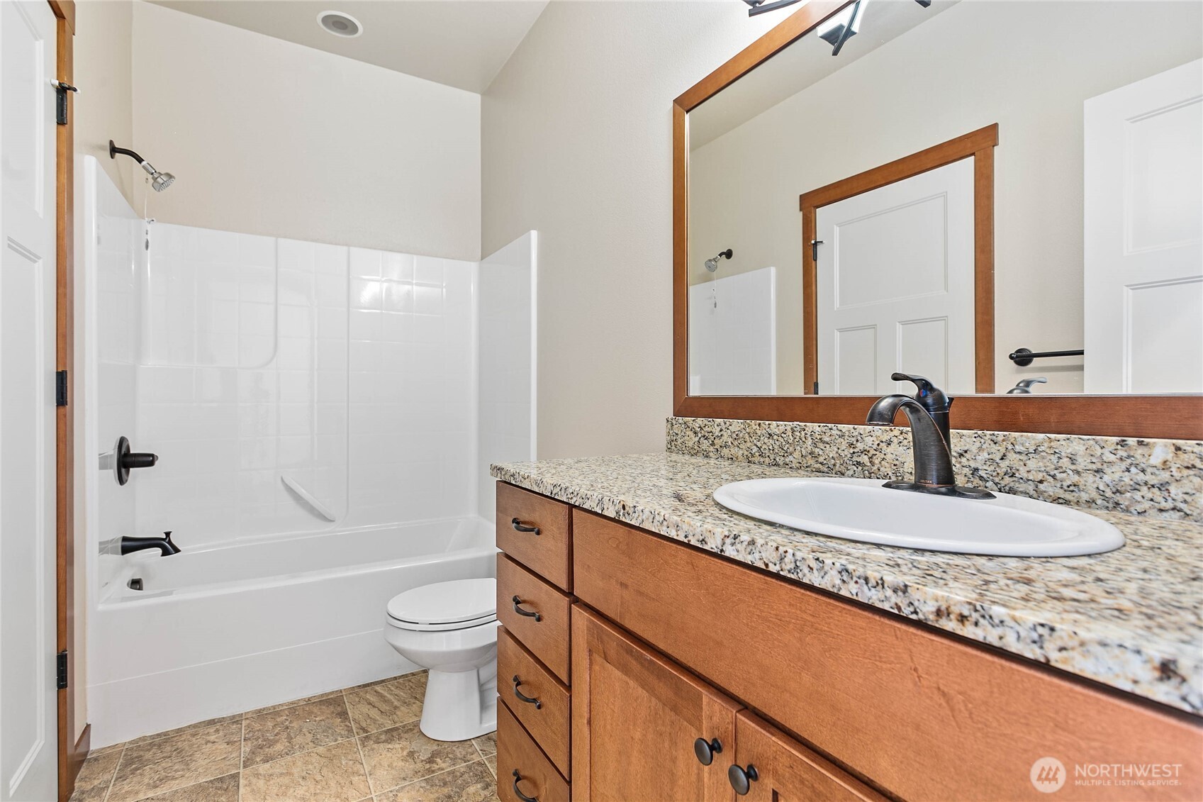 8780 Depot Road, Unit 308 Lynden, WA 98264 - Photo 12 of 36 a bathroom with a granite countertop sink toilet and shower