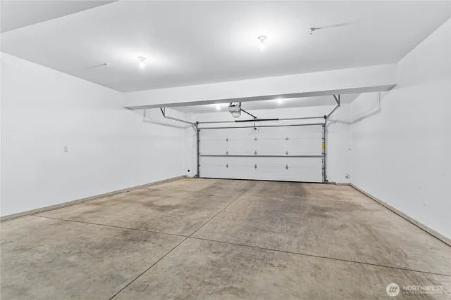 a group of people sitting in a room with kitchen view