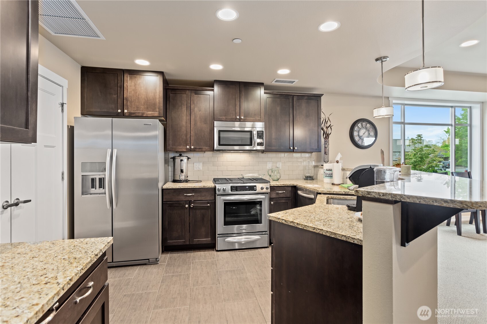 8780 Depot Road, Unit 308 Lynden, WA 98264 - Photo 28 of 36 a kitchen with stainless steel appliances granite countertop a sink a stove and a refrigerator