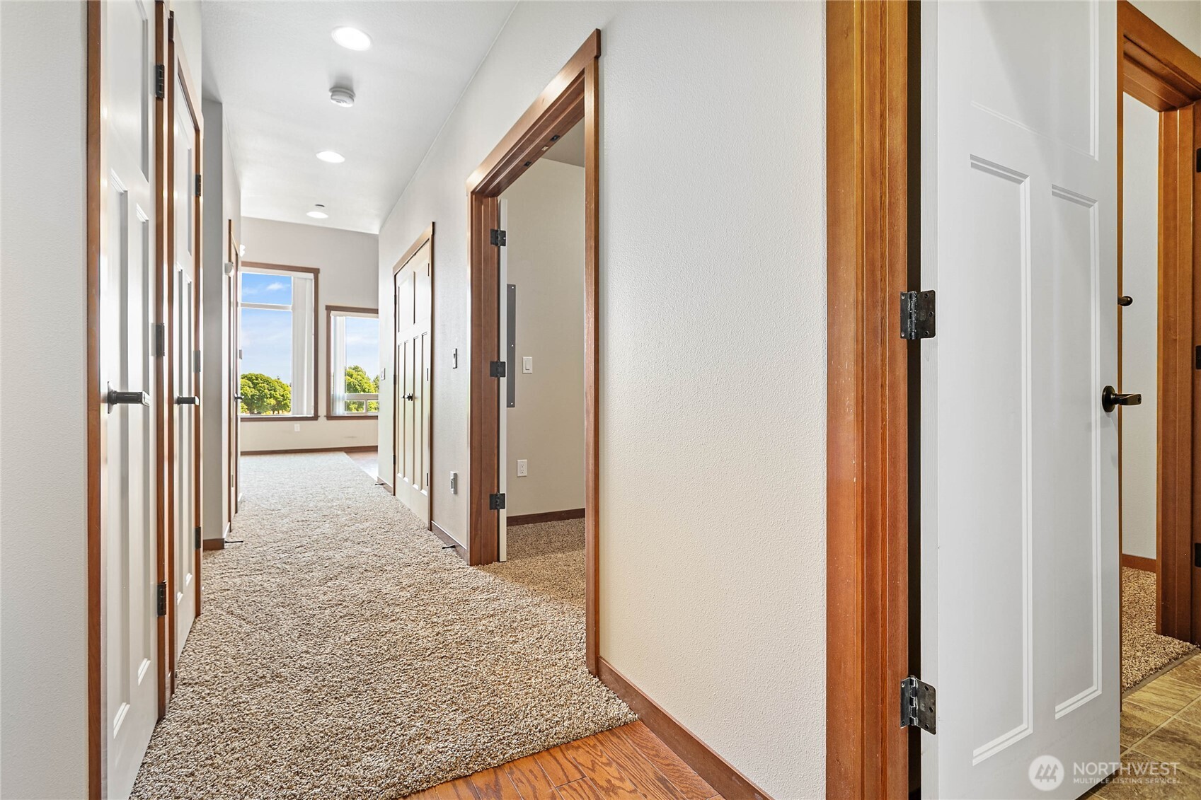 8780 Depot Road, Unit 308 Lynden, WA 98264 - Photo 4 of 36 a view of a hallway with wooden floor and a bathroom