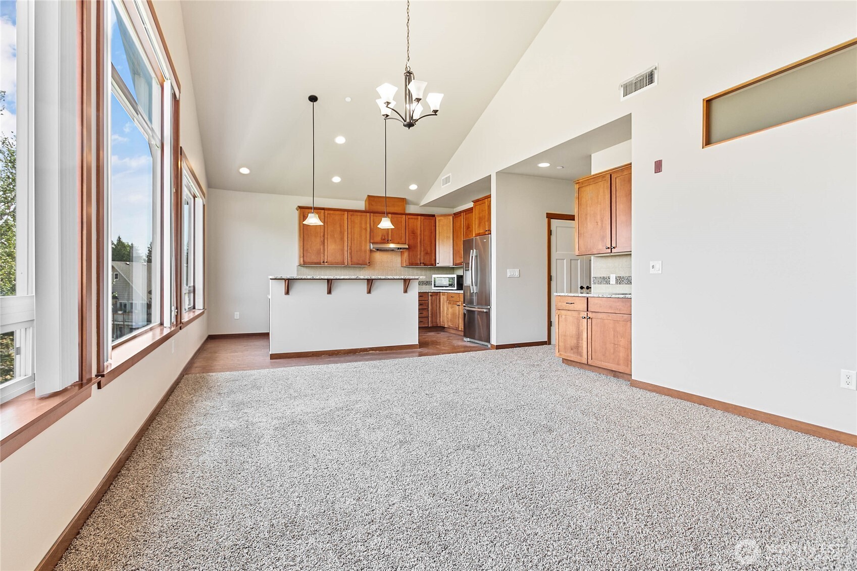 8780 Depot Road, Unit 308 Lynden, WA 98264 - Photo 5 of 36 a view of a kitchen with a refrigerator and a stove top oven