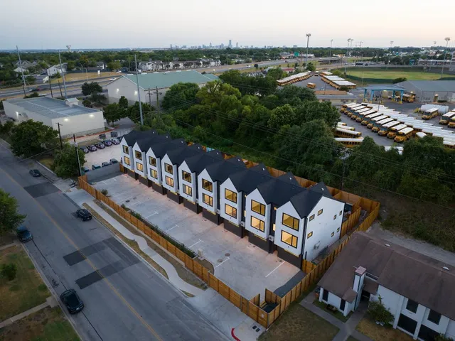a view of multiple houses with a street