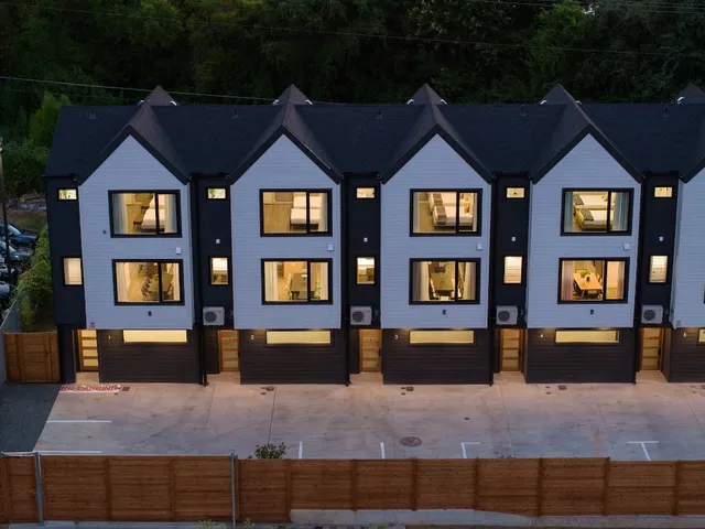 a front view of a residential apartment building with a yard