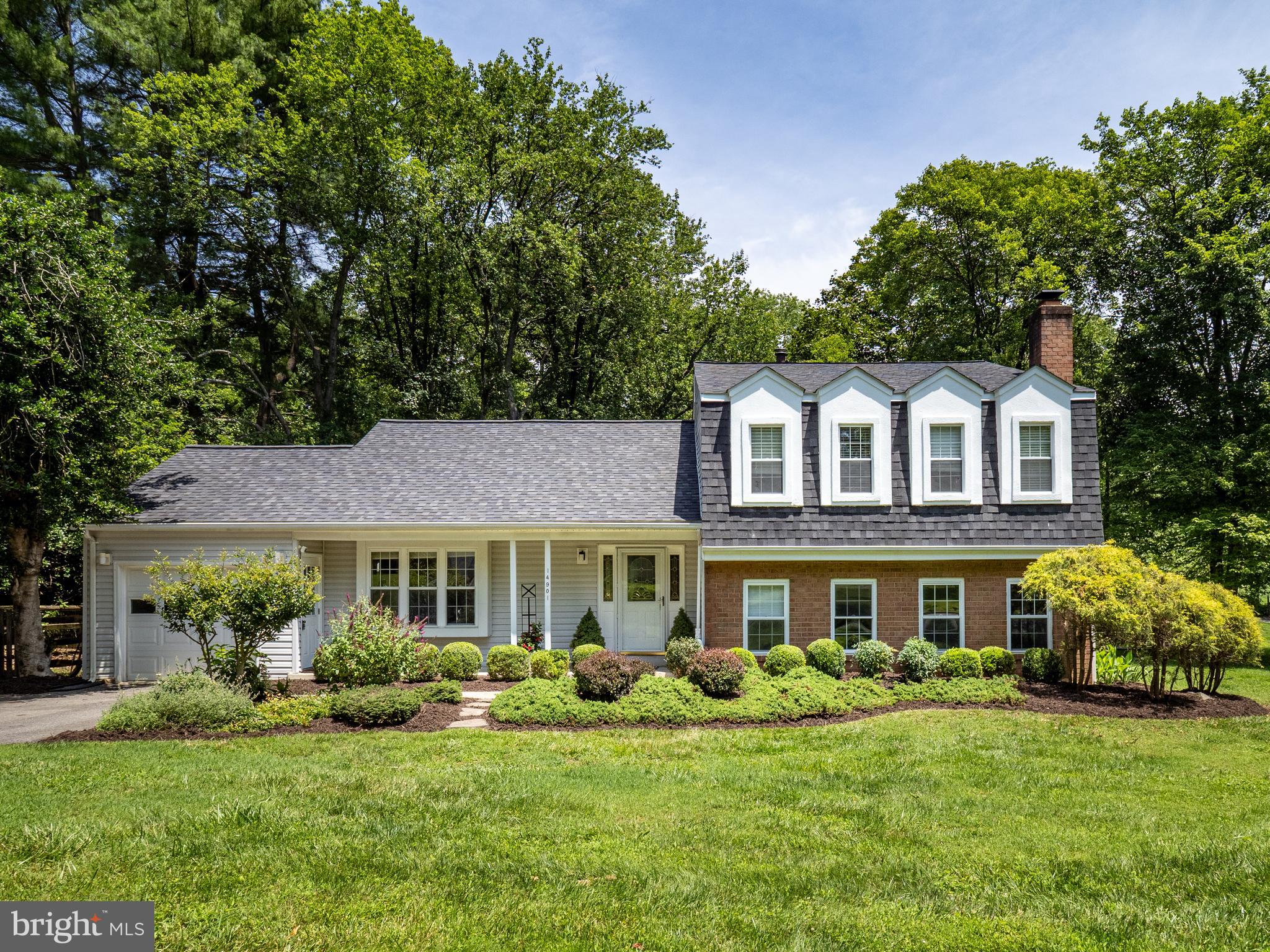 a front view of a house with a yard porch and furniture