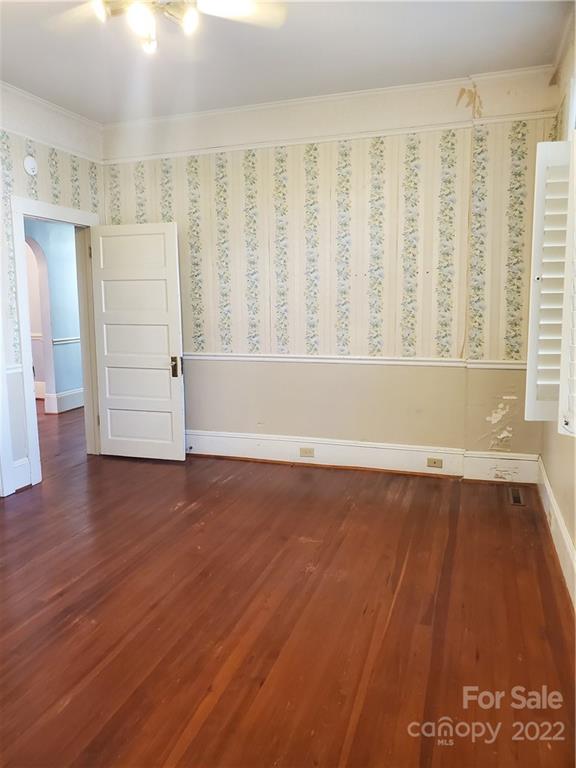 107 South Ridge Avenue, Unit 107 Kannapolis, NC 28083 - Photo 11 of 38 a view of an empty room with wooden floor and a window