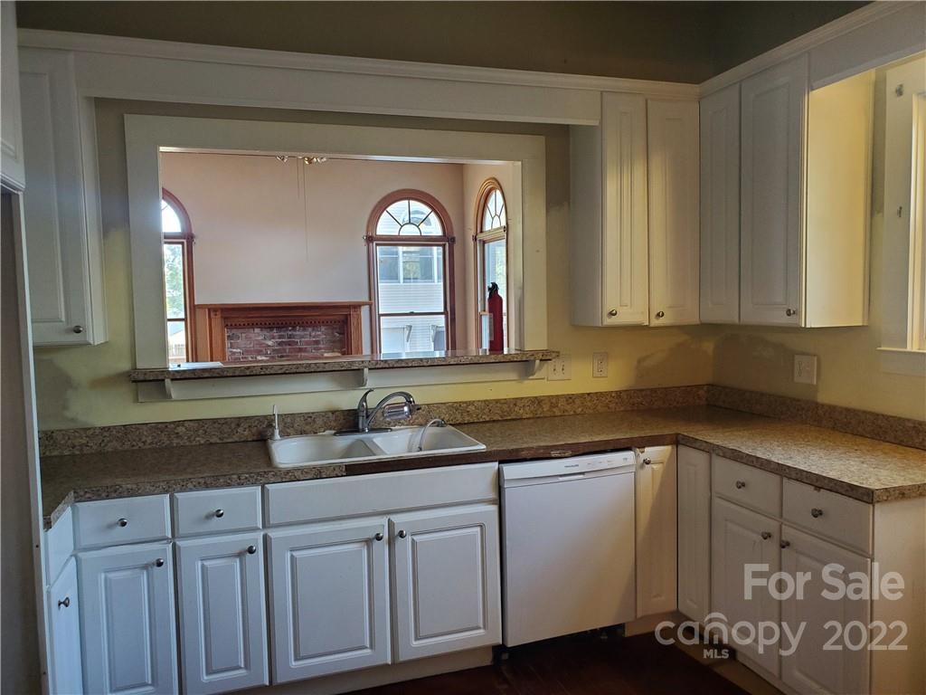107 South Ridge Avenue, Unit 107 Kannapolis, NC 28083 - Photo 15 of 38 a kitchen with granite countertop a sink and cabinets
