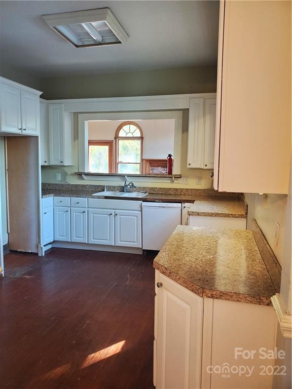 107 South Ridge Avenue, Unit 107 Kannapolis, NC 28083 - Photo 17 of 38 a kitchen with granite countertop sink and cabinets