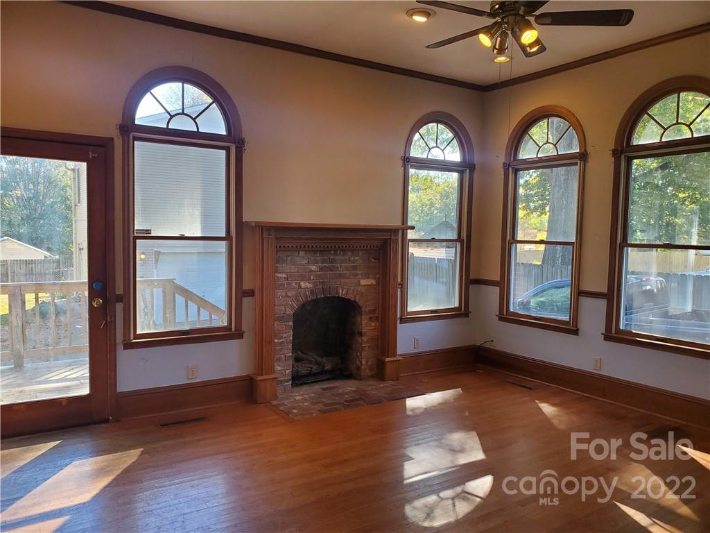 107 South Ridge Avenue, Unit 107 Kannapolis, NC 28083 - Photo 20 of 38 a view of an empty room with wooden floor fireplace and a window