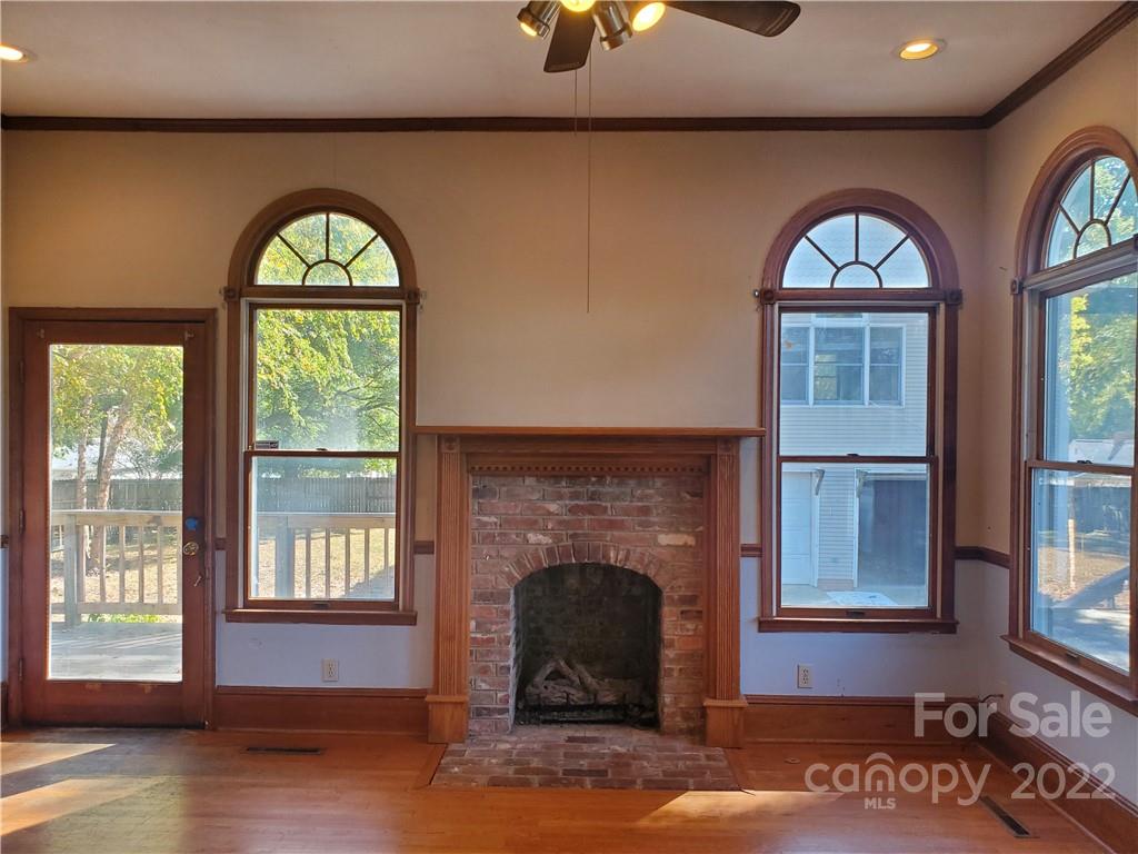107 South Ridge Avenue, Unit 107 Kannapolis, NC 28083 - Photo 21 of 38 a living room with a fireplace and windows