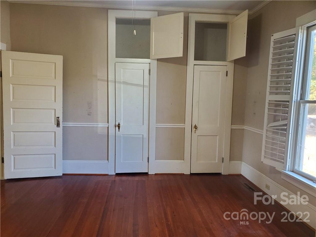 107 South Ridge Avenue, Unit 107 Kannapolis, NC 28083 - Photo 7 of 38 an empty room with wooden floor and windows