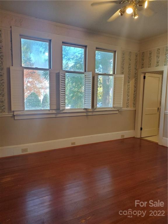 107 South Ridge Avenue, Unit 107 Kannapolis, NC 28083 - Photo 10 of 38 an empty room with wooden floor and windows
