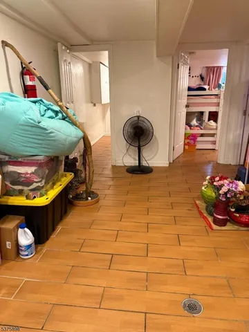 a bedroom with a bed and a tv on the dresser