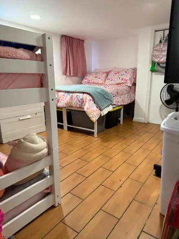 a bedroom with furniture and a mirror