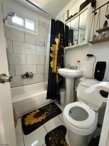 a view of kitchen and sink with cabinets