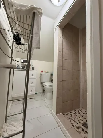 a living room with furniture and a dining table