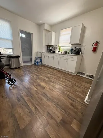 a kitchen with granite countertop a sink appliances and cabinets