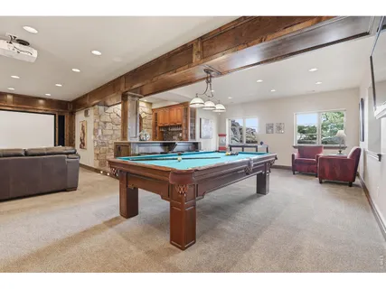 a room with pool table and couches