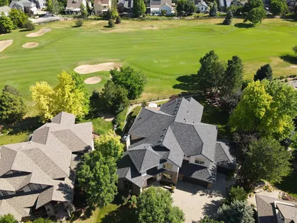 an aerial view of a house with ocean view