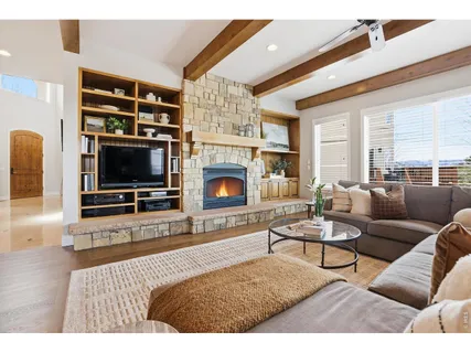 a living room with furniture flat screen tv and a fireplace