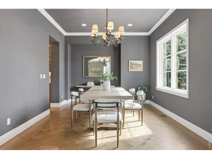 a view of a dining room with furniture and a chandelier