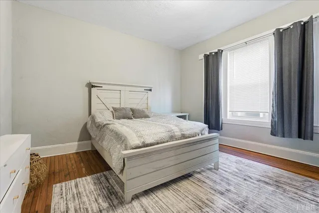 a bed sitting in a bedroom next to a window