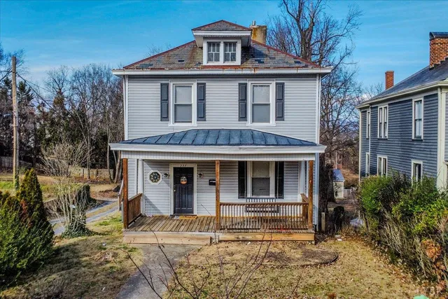 a house that has a large window in it with large trees