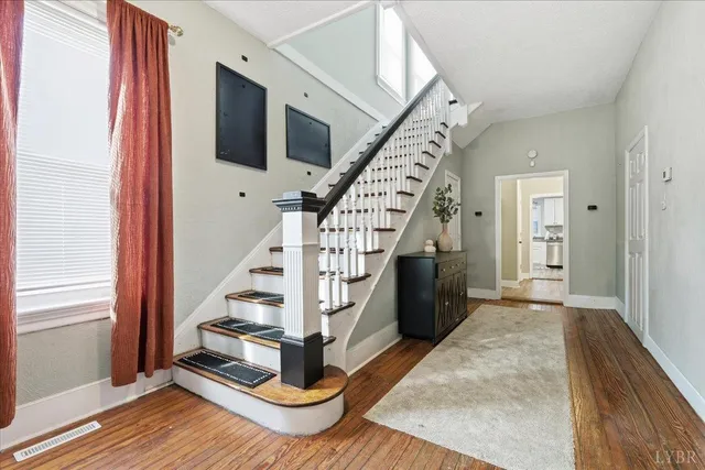 a view of entryway and hall with wooden floor
