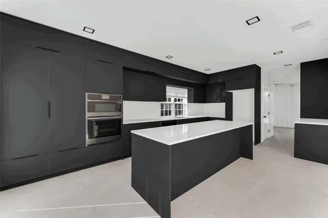 a kitchen with stainless steel appliances a refrigerator and a stove