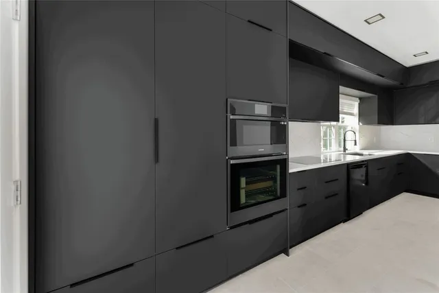 a kitchen with stainless steel appliances a refrigerator and a stove top oven