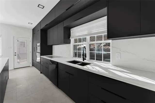 a kitchen with a sink and a stove