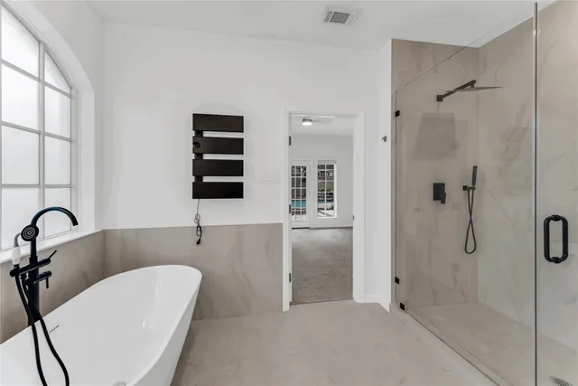 a bathroom with a double vanity sink a toilet a mirror and shower